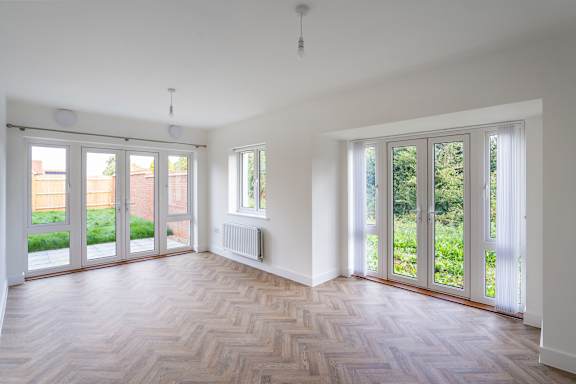 A room with a wooden floor and white walls.