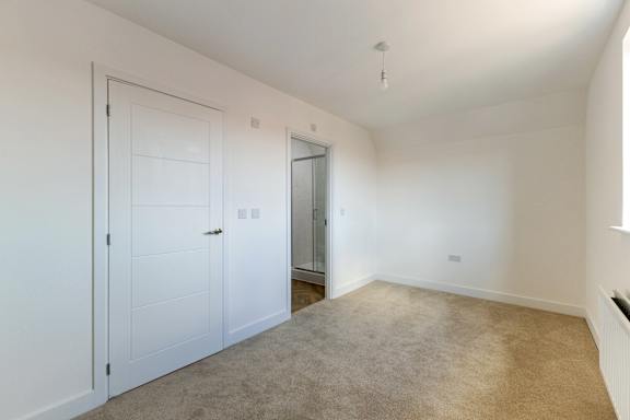 A room with white walls and a carpeted floor.