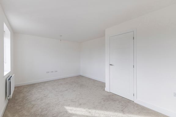 A white room with a door and a window.