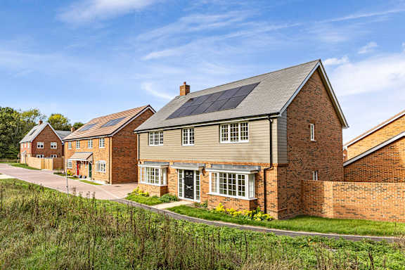 A row of houses with solar panels on the roofs.