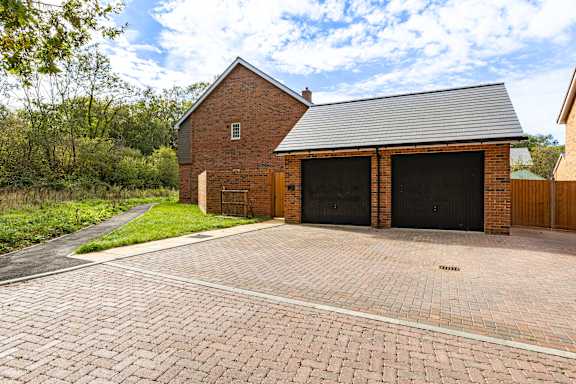 A brick house with a black garage door.