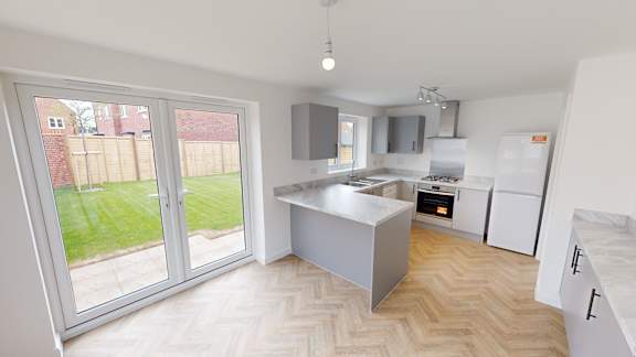 A kitchen with a white fridge and a marble countertop.