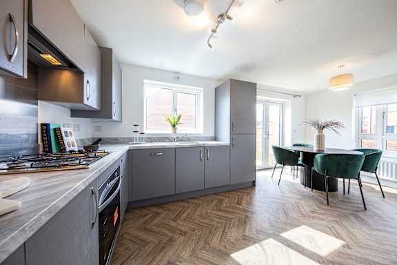 A modern kitchen with a dining area.