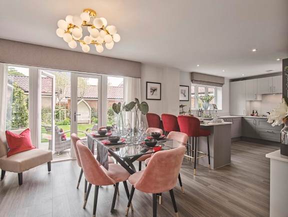 A modern dining room with a glass table and chairs.