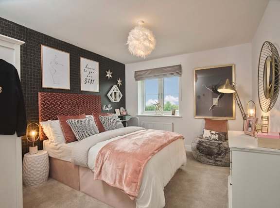 A bedroom with a large bed and a window.