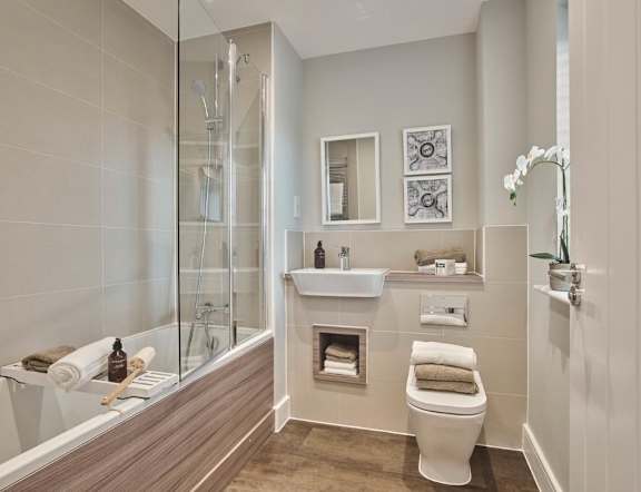 A bathroom with a toilet, sink, and shower.