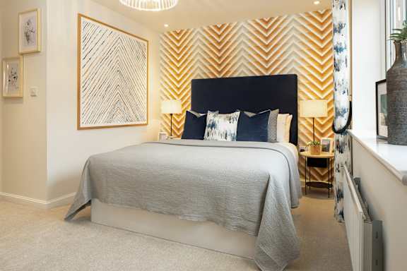 A bedroom with a large bed and a chandelier.