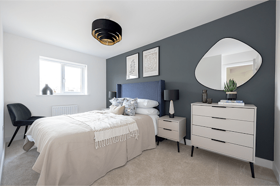 A bedroom with a bed, nightstand, and chair.