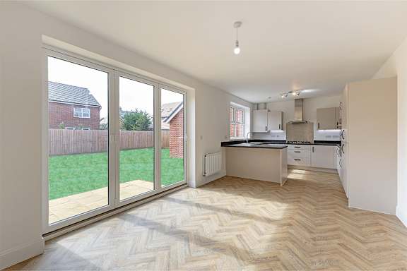 A kitchen with a herringbone patterned floor.