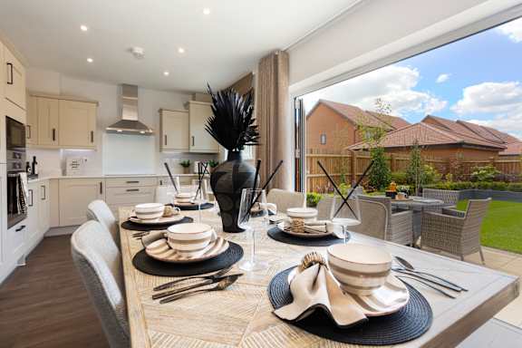 A modern dining room with a table set for a meal.