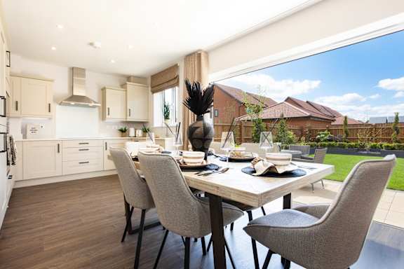 A modern dining room with a table set for four.