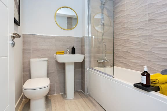 A bathroom with a toilet, sink, and bathtub.
