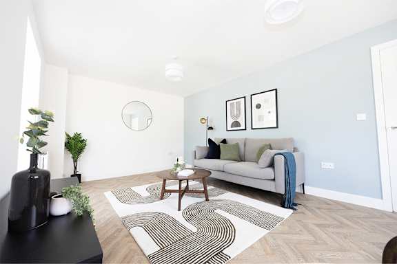 a living room with a couch and a rug