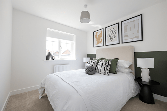 A bedroom with a large bed and a window.