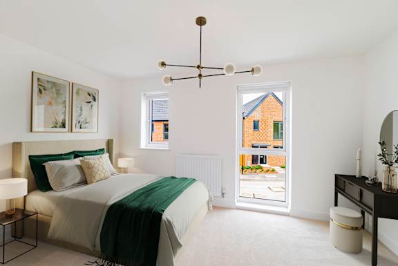 A bedroom with a large bed and a window overlooking a street.