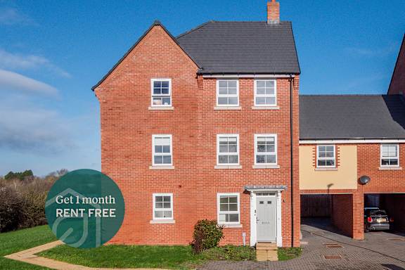 A red brick house with a sign offering a free month of rent.