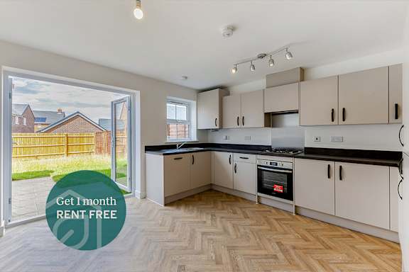 A kitchen with a sign offering a free month of rent.