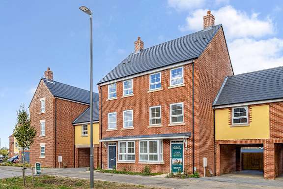 A row of houses with a blue sky in the background.