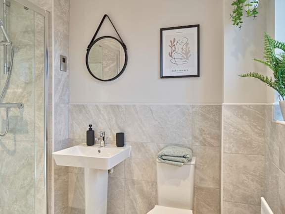 A bathroom with a white sink and toilet.