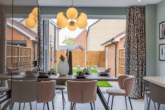 A dining room with a table set for six with chairs around it.