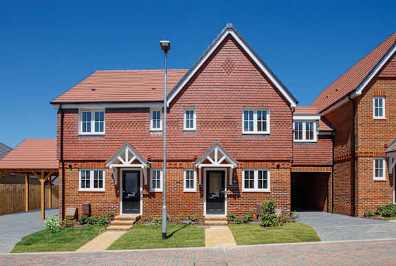 A red brick house with a black door and windows.