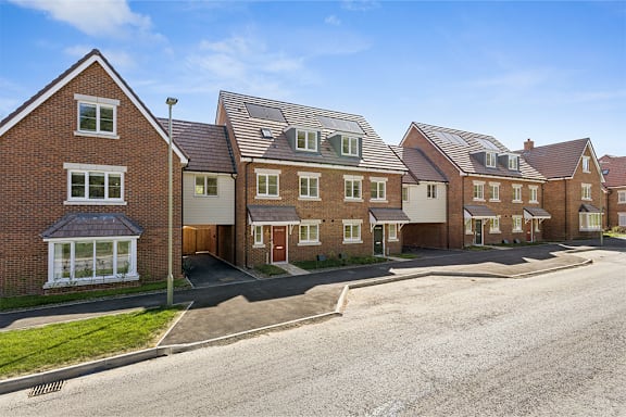 A row of houses with a clear blue sky above them.