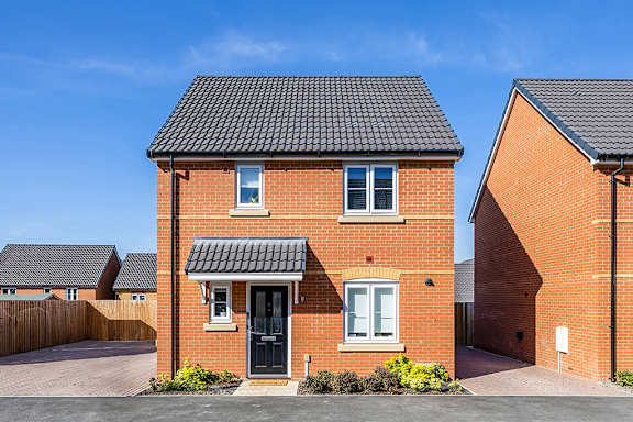 A red brick house with a black door and windows.