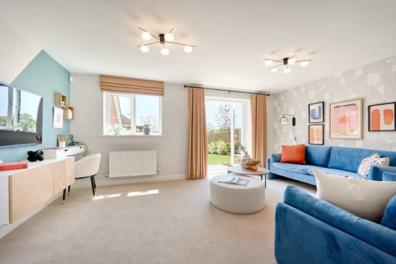 A living room with a blue couch and a white coffee table.
