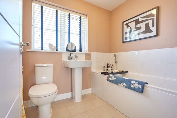 A bathroom with a toilet, sink, and bathtub.