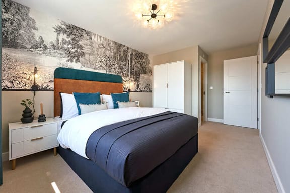 A bedroom with a large bed and a wallpapered wall.
