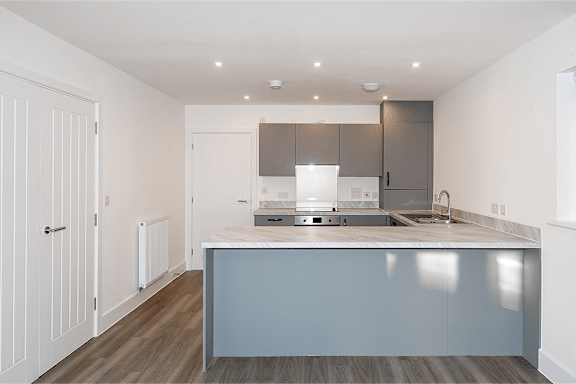 A modern kitchen with a large island and a sink.
