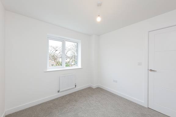 A room with a window and a door.