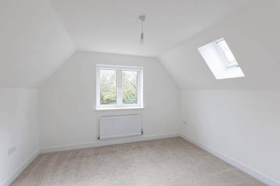 A room with a window and a skylight.
