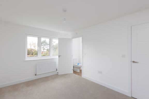 A white room with a window and a door.