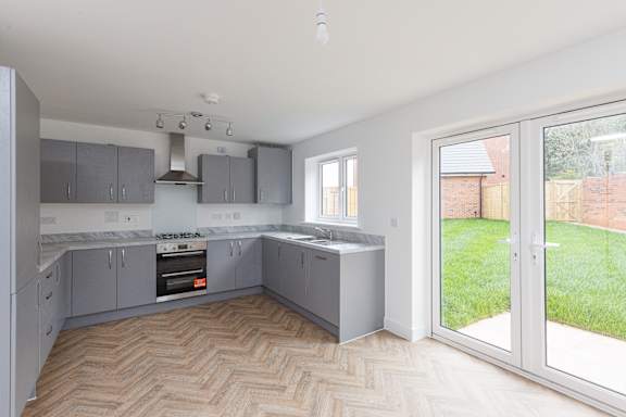 A kitchen with a herringbone patterned floor.