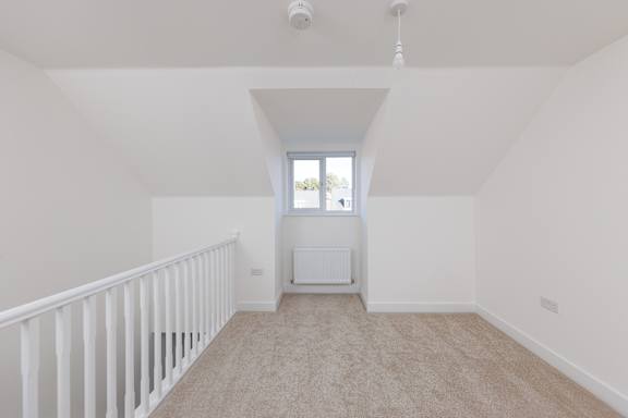 A room with a window and a radiator on the wall.