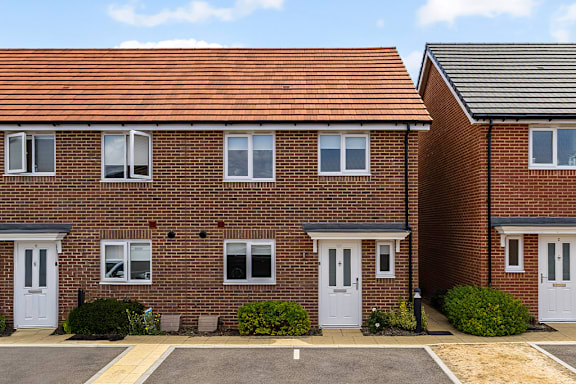 A row of houses with white doors and windows.