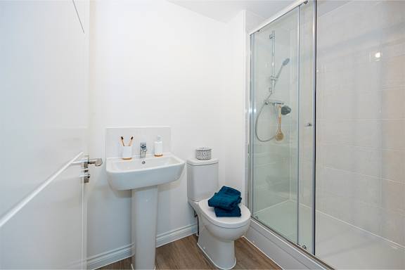 A white sink and toilet in a small bathroom.