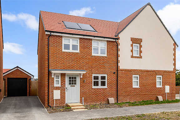 A red brick house with a white door and windows.