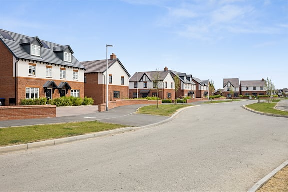A row of houses with a street in front.