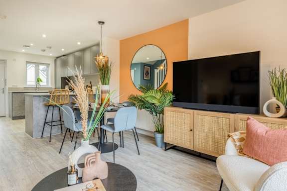 A modern living room with a bar area and a television.