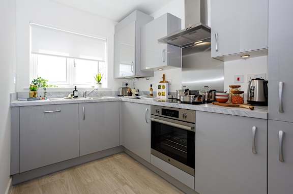 A modern kitchen with stainless steel appliances and white cabinets.