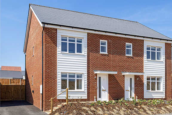 A red brick house with white windows and doors.