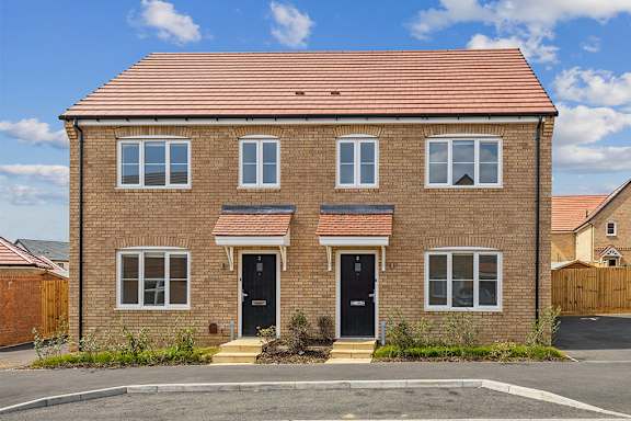 A red brick house with a black front door.