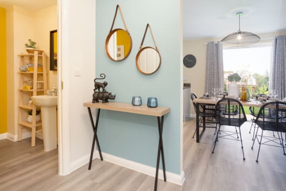a living room and dining room with a table and chairs