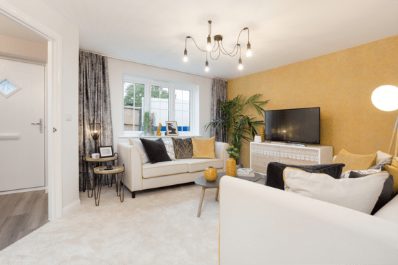 a living room with a white couch and a tv