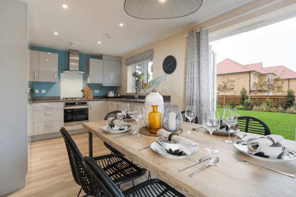 an open plan kitchen and dining area with a table and chairs