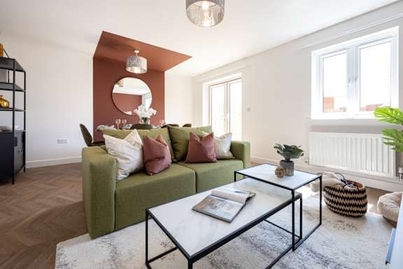 A living room with a green couch and a coffee table.