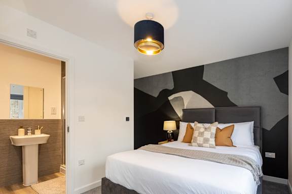 A bedroom with a large bed and a white sink.