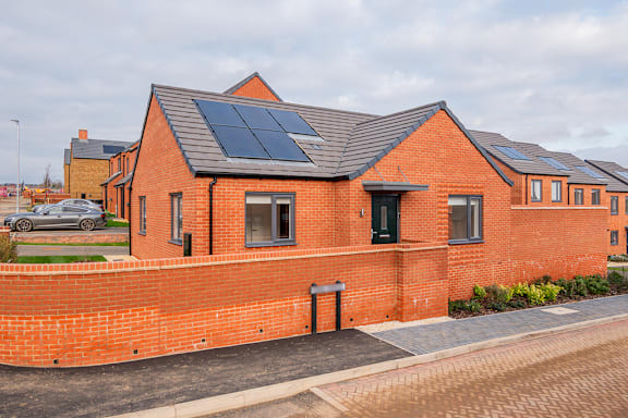 A red brick house with solar panels on the roof.